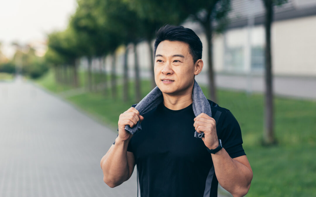 asian man after fitness workout and jogging happy man smiling shows thumb up and looks at camera.