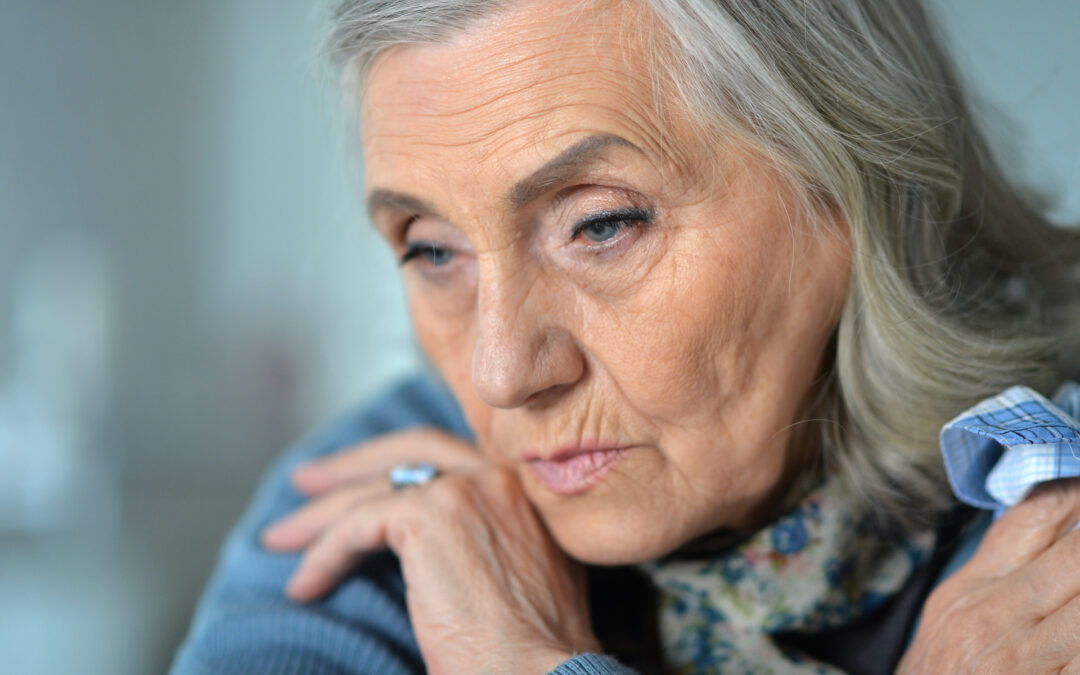 Portrait of sad senior woman at home in winter.