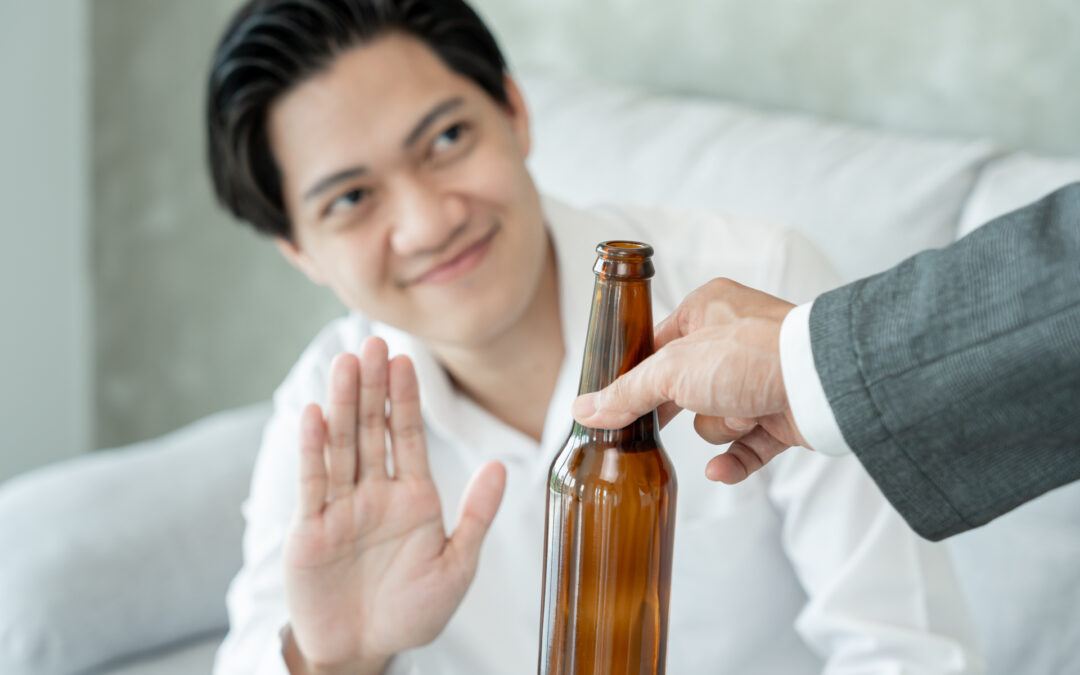 man smile and refuses say no and avoid to drink an alcohol , hand show reject and stopping, alcoholism treatment, alcohol addiction, quit booze, Stop Drinking Alcohol. Refuse bottle liquor, unhealthy